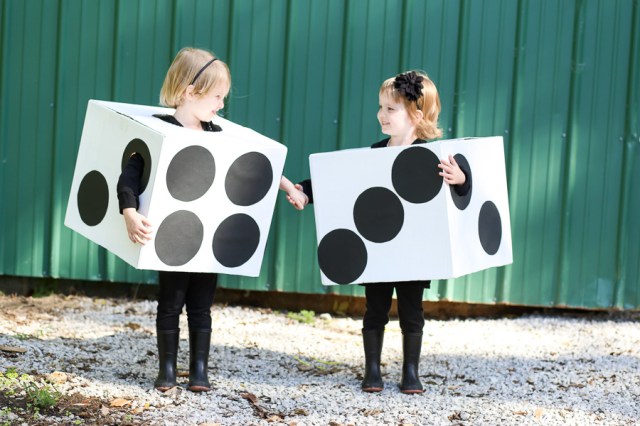 两位女孩穿万圣节服装 由纸板制作 令她们看起来像一对死